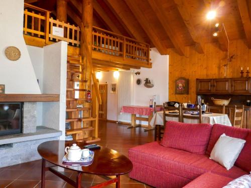 ein Wohnzimmer mit einem roten Sofa und einem Tisch in der Unterkunft Holiday Home Mona by Interhome in Leontica