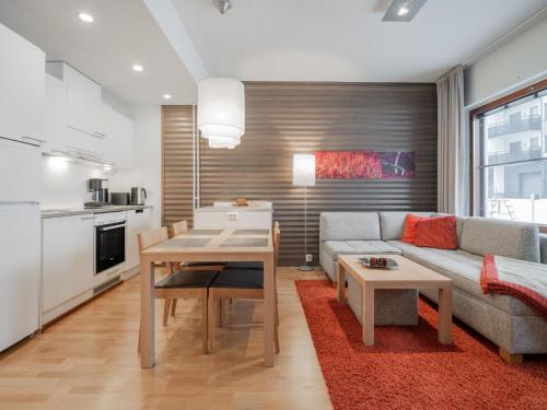 a living room with a couch and a table at Holiday Home Nordic chalet 9211 by Interhome in Ylläs