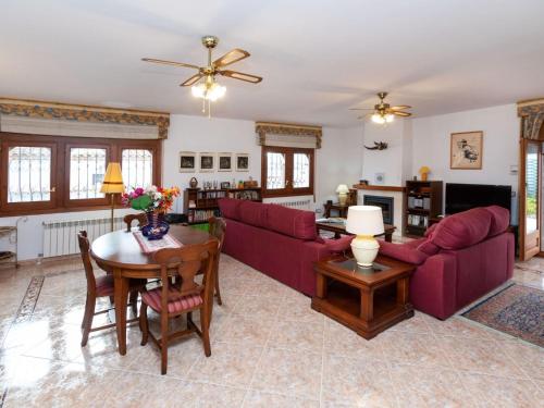 a living room with a red couch and a table at Villa Rustical Mont Roig by Interhome in Miami Platja