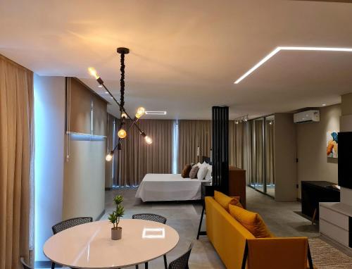 a living room with a bed and a table and chairs at Seasons BC in Cabeçudas