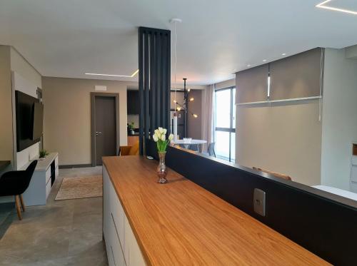a kitchen with a counter with a vase of flowers on it at Seasons BC in Cabeçudas
