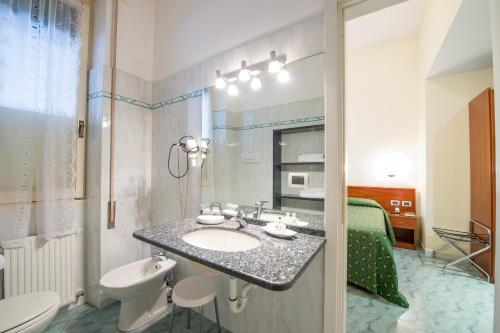 a bathroom with a sink and a toilet at Hotel Giulio Cesare in Rapallo