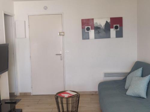 - un salon avec un canapé et une porte en verre dans l'établissement Apartment Terrasses de la Baronnie-5 by Interhome, au Grau-du-Roi