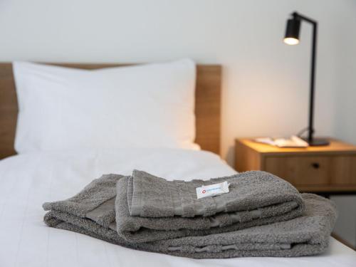 a pile of towels sitting on top of a bed at Apartment LocTowers A3-4-2 by Interhome in Locarno