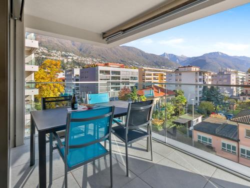 uma varanda com uma mesa e cadeiras e uma vista em Apartment LocTowers A3-4-3 by Interhome em Locarno