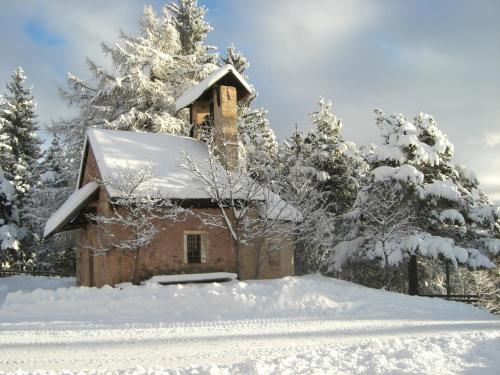 a small building in the snow with snow covered trees at Gasthof St. Ulrich in Meltina
