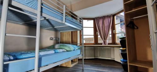 a room with two bunk beds and a window at Gasthof Hirschen in Pfunds