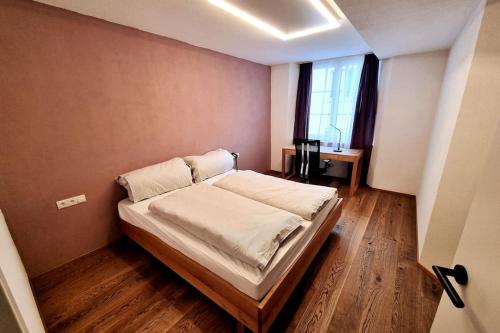 a bedroom with a bed in a room with a window at Appartment Wolf Huber im Zentrum der Altstadt. in Feldkirch
