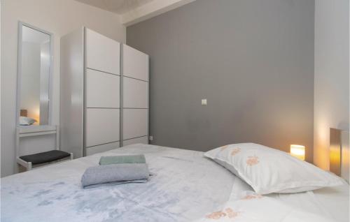 a bedroom with a large white bed and a mirror at 2 Bedroom Amazing Home In Vela Luka in Vela Luka