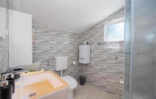 a bathroom with a sink and a toilet at 2 Bedroom Amazing Home In Vela Luka in Vela Luka