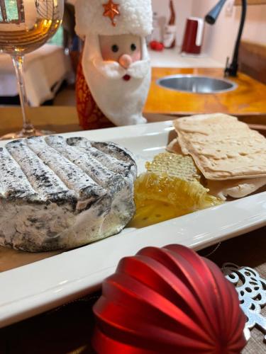 a plate of food on a table with a snowman behind it at VILLA ITÁLIA CHALÉ in Santo Antônio do Pinhal