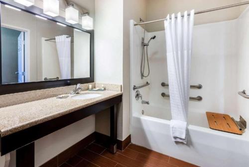 a bathroom with a sink and a tub and a shower at La Quinta by Wyndham Roswell in Roswell