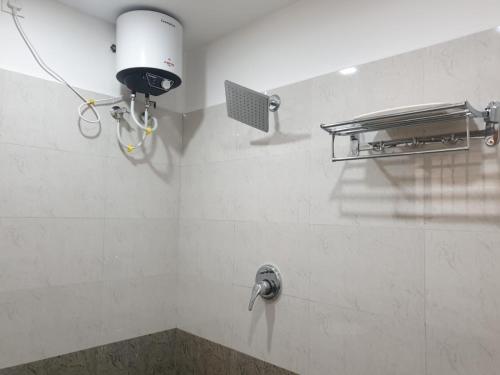 a bathroom with a water faucet on a wall at Kanmani Elite- A Perfect Home in Tiruchirappalli