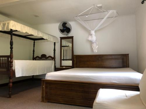 a bedroom with two beds and a mirror at No.53 in Katunayaka
