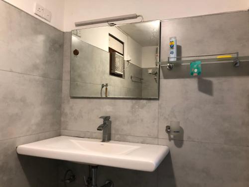 a bathroom with a sink and a mirror at No.53 in Katunayake