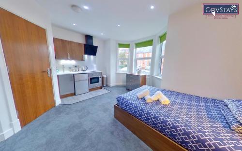 a bedroom with a bed with two pillows on it at Victoria House - Deluxe Studios in Coventry City Centre, free parking, by COVSTAYS in Coventry