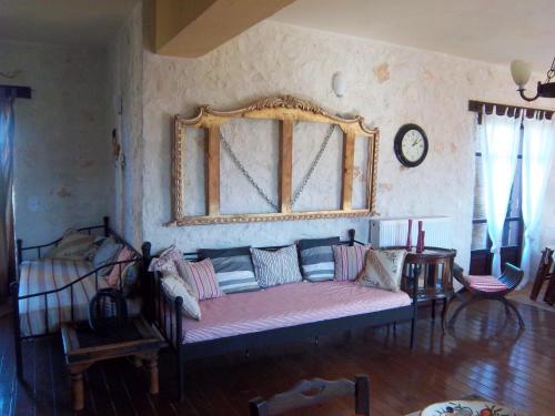 a living room with a couch and a window at Alegria Villas Complex in Vasilikos
