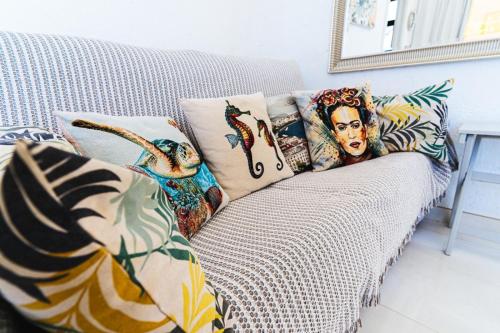 a couch with pillows on it in a living room at 1001 Ocean view house - Puerto Rico in Mogán