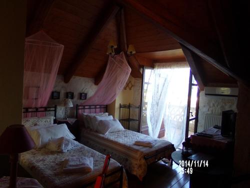 a bedroom with two beds and a window at Alegria Villas Complex in Vasilikos