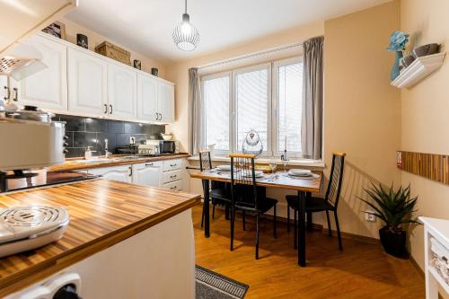 a kitchen with a table and chairs in it at Old Town Vintage Apartment Sturova in Košice