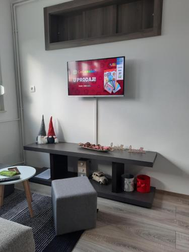 a living room with a tv on the wall at Apartman Ines in Velika Gorica