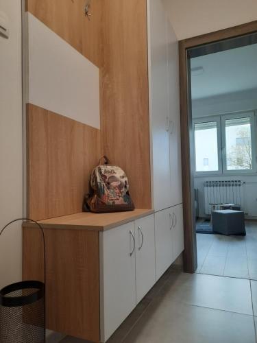 a kitchen with white cabinets and a large mirror at Apartman Ines in Velika Gorica