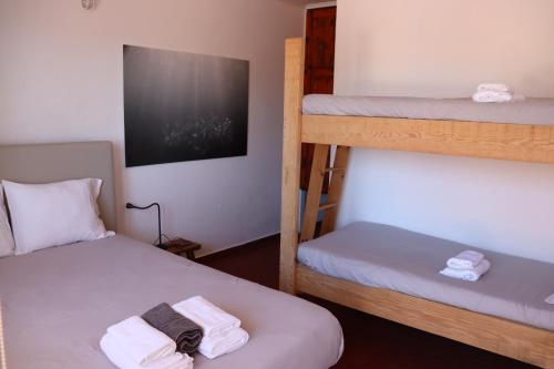 a room with two bunk beds with towels on them at BerlengaBed&Breakfast in Peniche