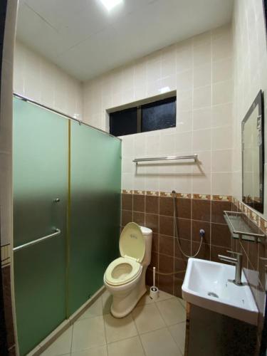 a bathroom with a toilet and a sink at D'Village Batu Berendam, Melaka in Ayer Keroh