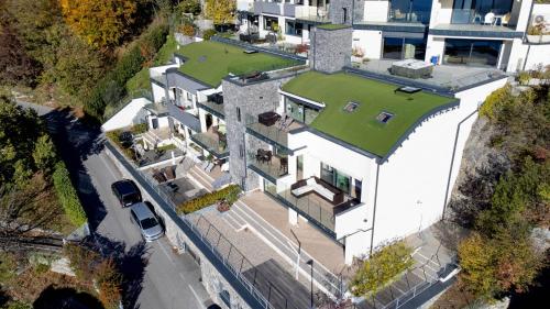 an overhead view of a large house with a green roof at THE VIEW!!! by Design Studio in Perledo