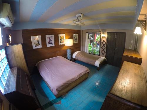 a bedroom with two beds in a room at The Riverside Guest House in Lampang