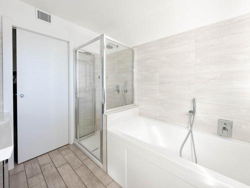 a white bathroom with a tub and a shower at THE VIEW!!! by Design Studio in Perledo