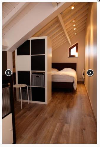 a bedroom with a bed and a book shelf at Gite-ardennes & wellness - Ovifat - Coquelicots 7 pers in Ovifat