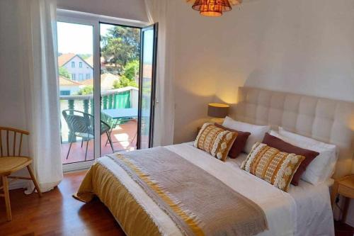 ein Schlafzimmer mit großem Bett und Balkon in der Unterkunft Fabulous Terrace Cascais - Checkinhome in Cascais