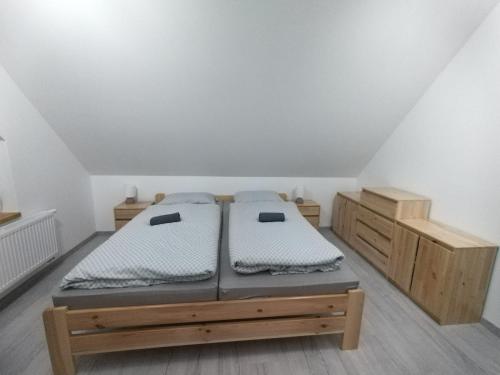 a bedroom with two beds and wooden cabinets at Rekreačný dom pod Smrekovom in Lúčky