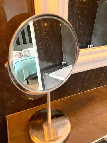 a mirror sitting on top of a table at La Maison Gervaiserie & Spa in Réville