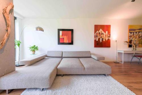 a living room with a large couch and a table at trendy STUDIO ROTTERDAM CENTER in Rotterdam