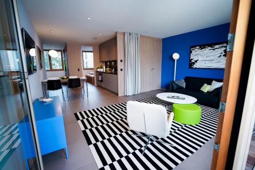 a living room with a couch and a table at Max Lodging Serviced Apartments in Munich
