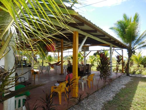a person sitting under a pavilion at a restaurant at Hotel Nuquimar in Nuquí