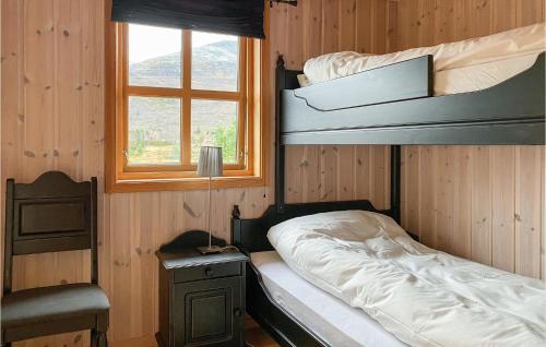 a bedroom with a bunk bed and a window at Awesome Home In Straumgjerde With Sauna, 4 Bedrooms And Wifi in Brunstad