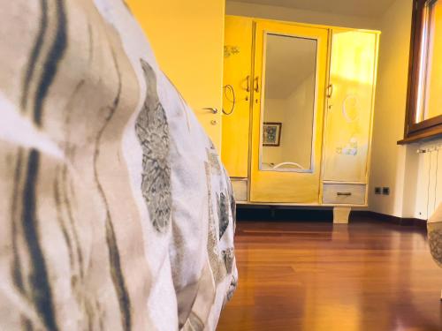 a close up of a bed in a room with a mirror at Tenuta MonteOliveto - Family Cottage - Agriturismo nelle Langhe in Vesime