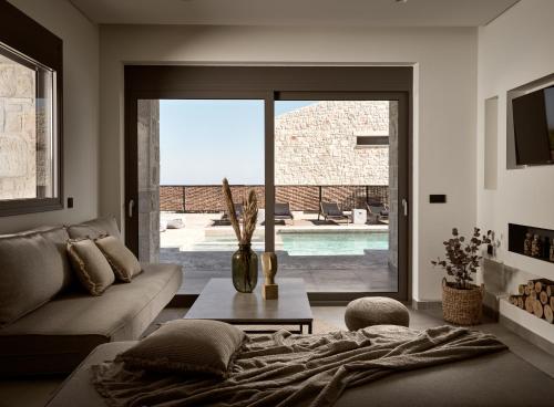 a living room with a couch and a table at Seaside Luxury LaSoleil Villa, Zante Zen By ThinkVilla in Psarou