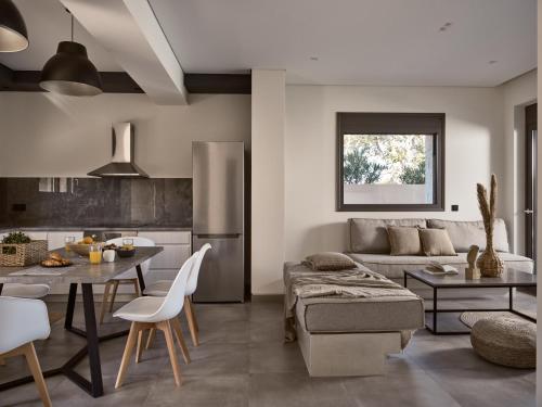 a kitchen and living room with a couch and a table at Seaside Luxury LaSoleil Villa, Zante Zen By ThinkVilla in Psarou