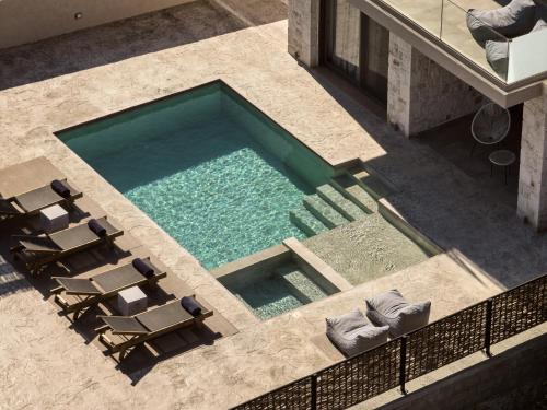 an overhead view of a swimming pool with chaises and chairs at Seaside Luxury LaSoleil Villa, Zante Zen By ThinkVilla in Psarou