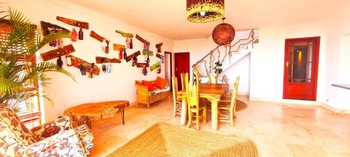 a living room with a table and a dining room at Beachwood Camps Bay in Cape Town