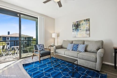 a living room with a couch and a large window at Ascent North Scottsdale Pool Gym Apartments Near Mayo and Scottsdale Quarter in Scottsdale