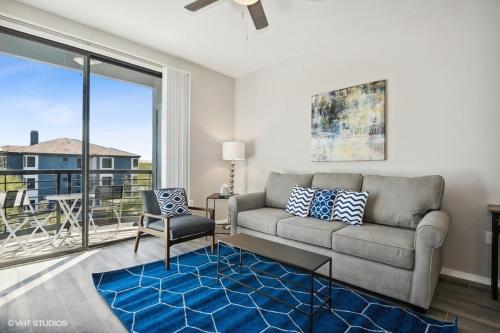 a living room with a couch and a large window at Ascent North Scottsdale Pool Gym Apartments Near Mayo and Scottsdale Quarter in Scottsdale