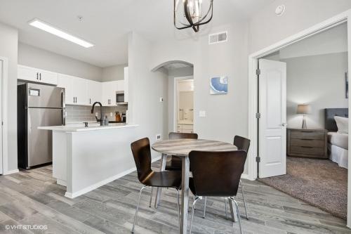 a kitchen and dining room with a table and chairs at Ascent North Scottsdale Pool Gym Apartments Near Mayo and Scottsdale Quarter in Scottsdale