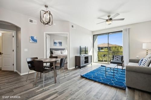 a living room with a table and a couch at Ascent North Scottsdale Pool Gym Apartments Near Mayo and Scottsdale Quarter in Scottsdale