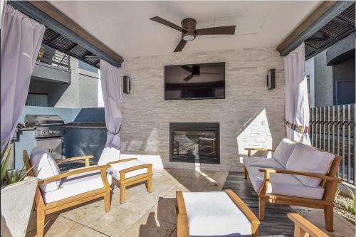 a living room with chairs and a fireplace at Ascent North Scottsdale Pool Gym Apartments Near Mayo and Scottsdale Quarter in Scottsdale