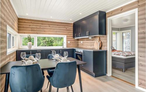 a kitchen with a table and chairs and a bed at Stunning Home In Gjemnes With Wifi in Stokke